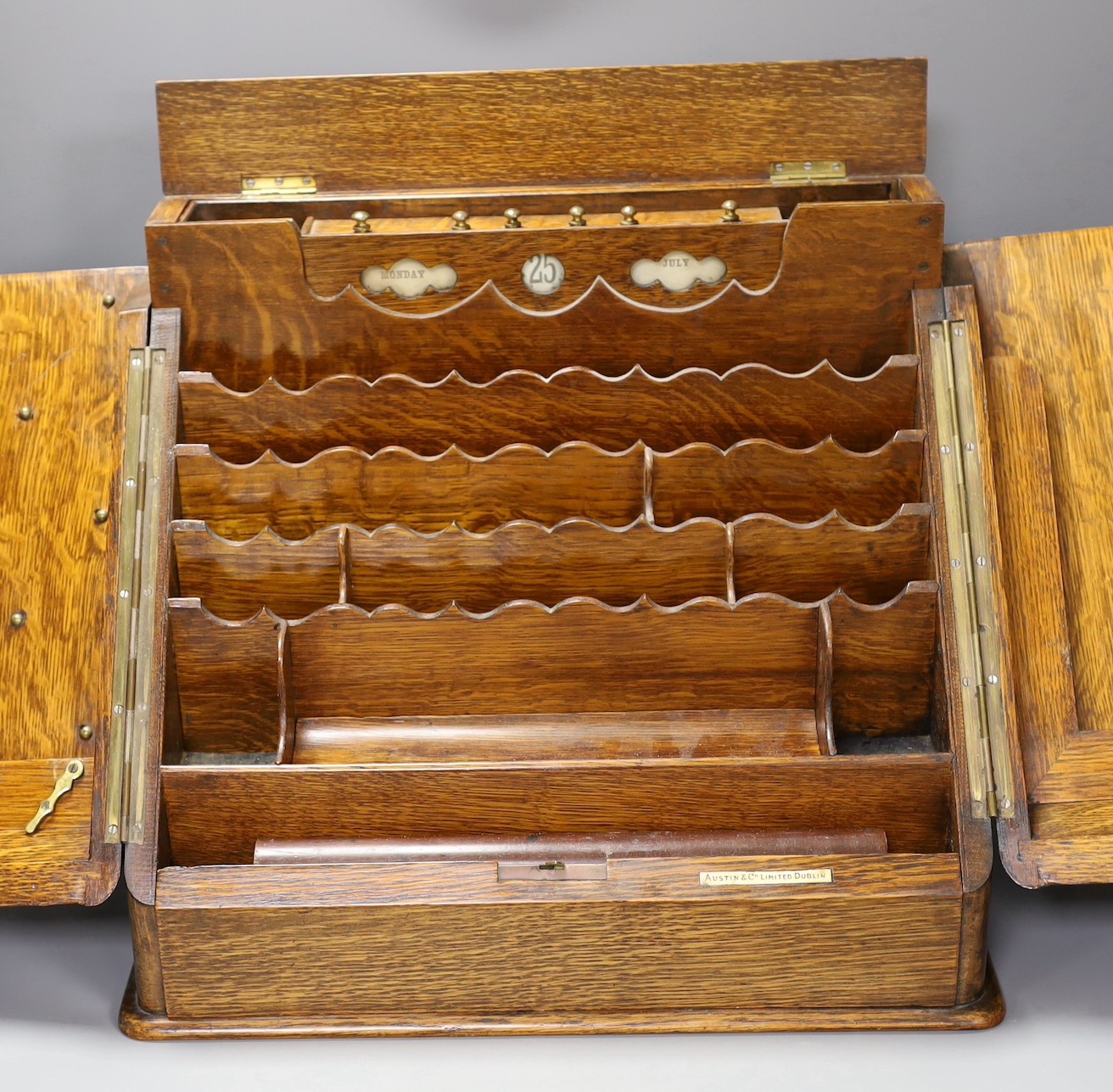 An Edwardian oak two door stationary box, 36 cms high